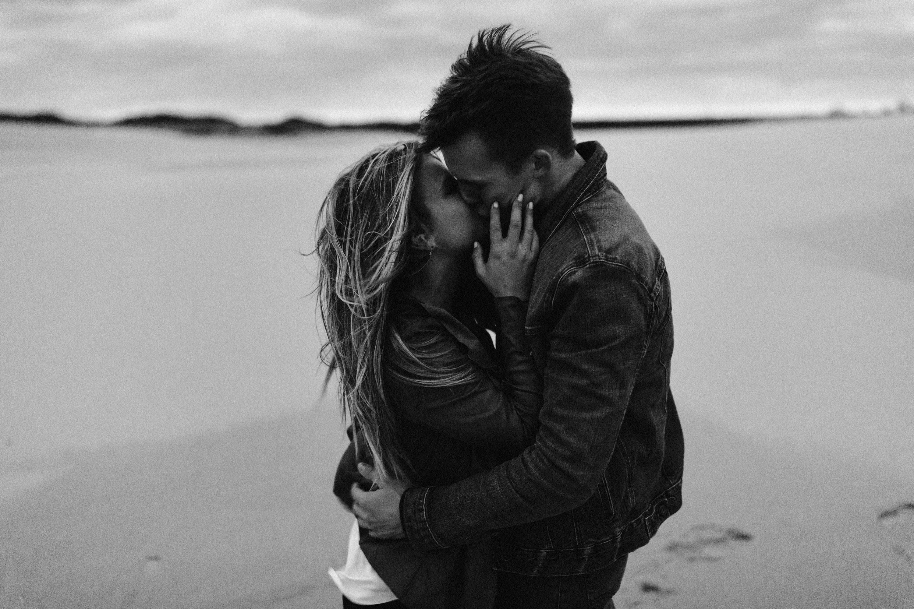Couple hugging and keeping each other warm from the wind Romantic, Desert-Themed, Engagement Session, Josh Rexford